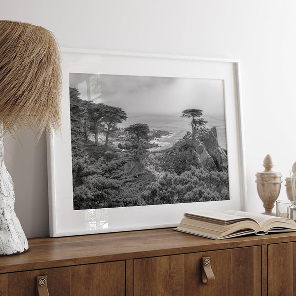 Black and white fine art coastal print featuring a lone cypress overlooking the ocean along 17-Mile Drive near Monterey, California. Available framed or unframed.