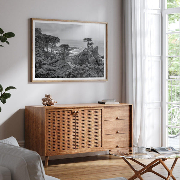 Black and white fine art coastal print featuring a lone cypress overlooking the ocean along 17-Mile Drive near Monterey, California. Available framed or unframed.
